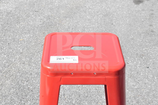 Red Tolix Style Bar Stool, brand new with minor scratches and dents, features a square seat with a handle cutout. Auction label reads "261 7/14 QTY x3."