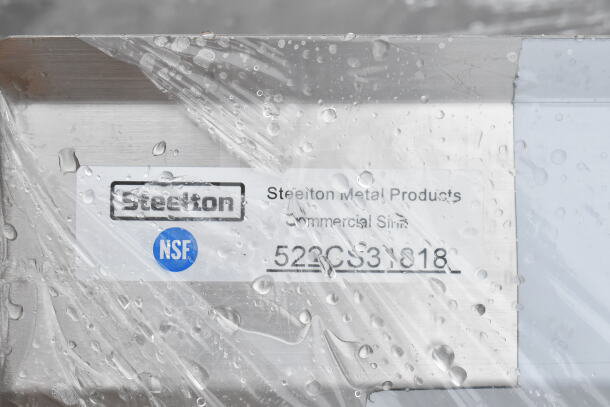 Brand new Steelton 522CS31818 commercial sink label in crate, showing model number and NSF certification.