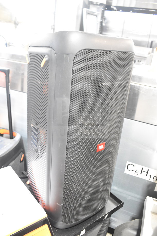 Store display featuring a JBL Partybox 300 speaker, black with mesh front, JBL logo, in excellent condition.