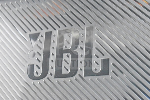 JBL logo on a textured surface of the Partybox 300 speaker.
