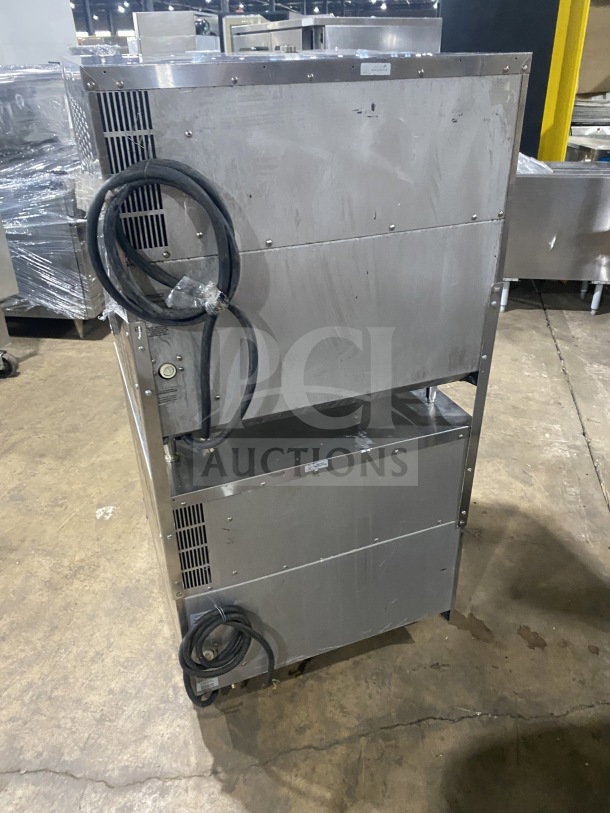 Stainless steel Turbofan Moffat E32D5 double-stacked convection oven on casters, showing electric cords and vents.