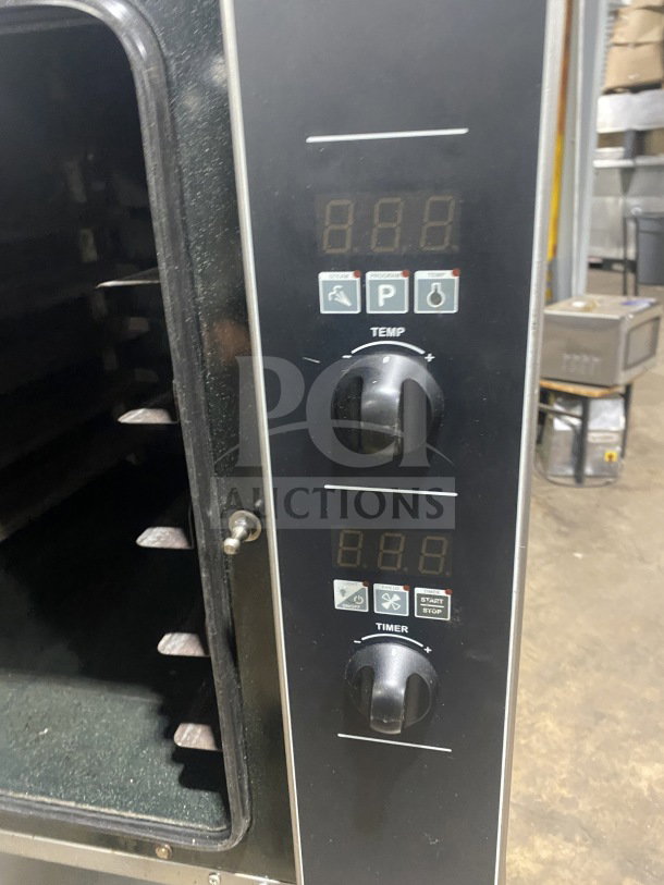 Turbofan Moffat E32D5 convection oven with steam injection, digital controls, and casters, showing temperature and timer dials.