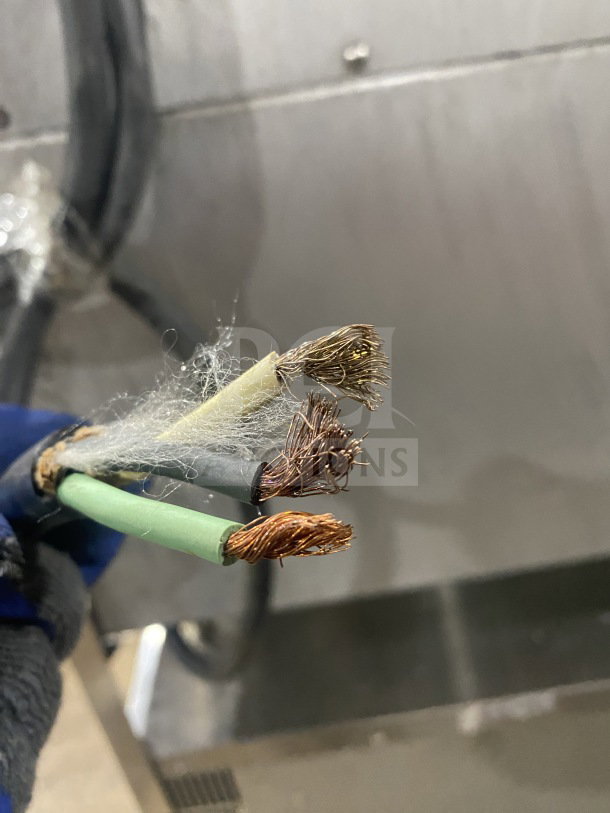 Frayed electrical wires of a Turbofan Moffat E32D5 convection oven, needing repairs for safe operation.