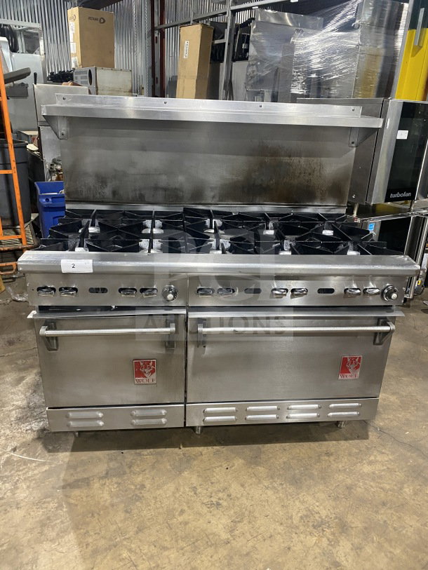 Wolf stainless steel natural gas 8-burner range with double oven, backsplash, and salamander shelf. Model C56D538.