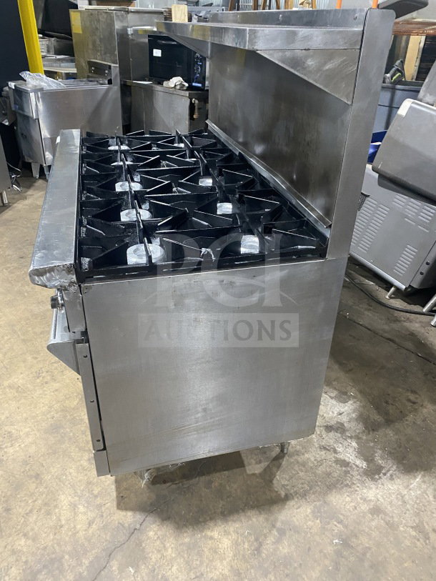 Wolf Commercial Stainless Steel 8-burner range with double oven, backsplash, salamander shelf, and wired rack, Model C56D538.