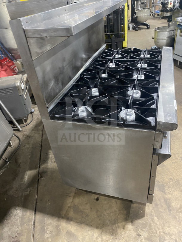 Wolf Commercial Stainless Steel 8-burner range with double oven, overhead salamander shelf, model C56D538, SN: 656011423.