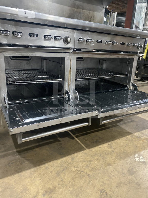 Wolf commercial stainless steel 8-burner range and double oven combo with backsplash and salamander shelf. Model C56D538.