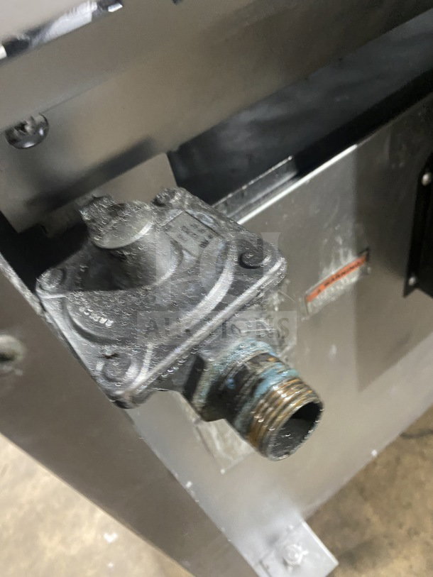 Close-up of natural gas connection on a Wolf stainless steel 8-burner range and double oven combo, Model: C56D538.