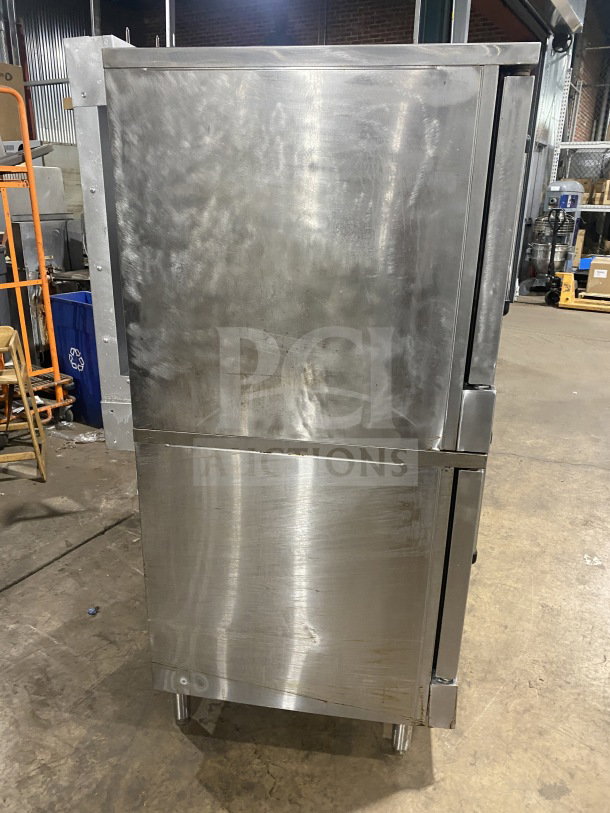 Southbend commercial stainless steel double stacked gas convection oven with thermostatic control, wired oven rack, on legs.