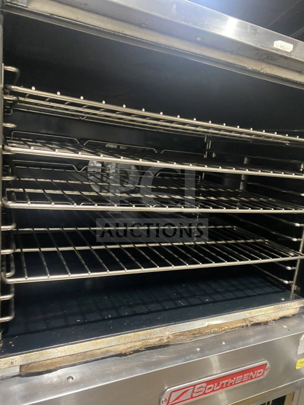 Southbend stainless steel double-stacked convection oven with thermostatic control, wire racks, and legs.