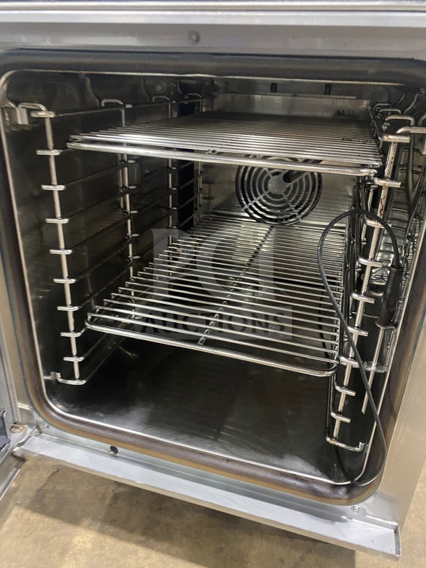 Alto-Shaam CTX4-10EC stainless steel combi oven with wired rack, 208-240V, 3 phase, touchscreen, on legs.