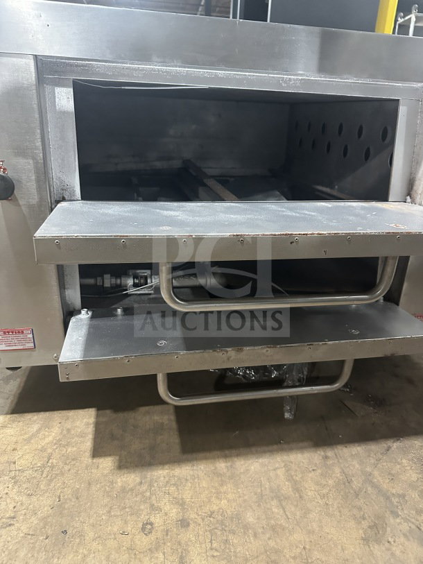 Attias commercial stainless steel gas-powered countertop double deck pizza oven, open doors, slight wear, durable handles.