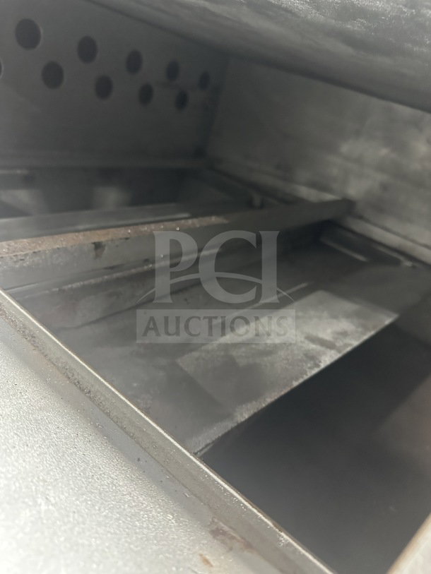 Attias stainless steel double deck gas pizza oven, countertop model, in used condition. Visible interior baking chambers.