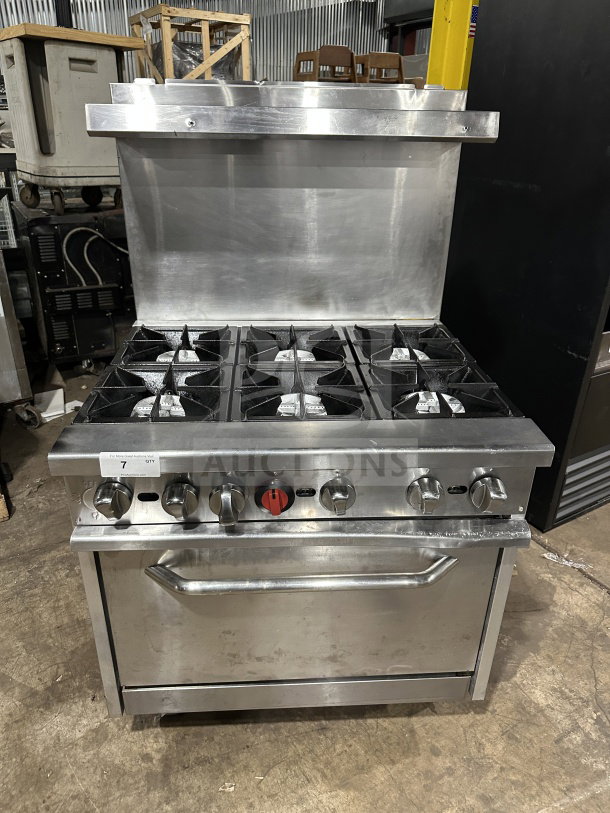 Qualite stainless steel gas range/oven model QLG36NG with salamander shelf, backsplash, and casters. Includes wired oven rack.