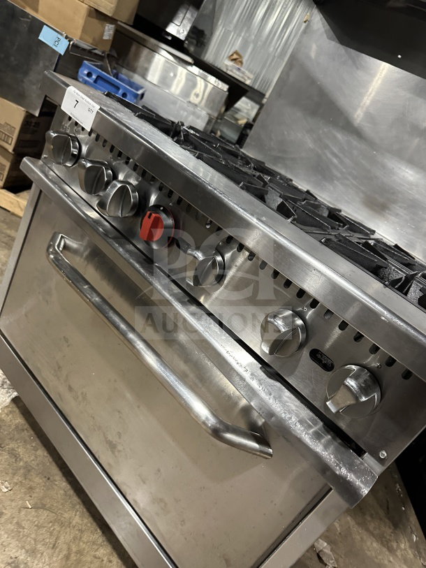 Qualite stainless steel gas range/oven, model QLG36NG, with backsplash, salamander shelf, and rack. Serial: 05230084.
