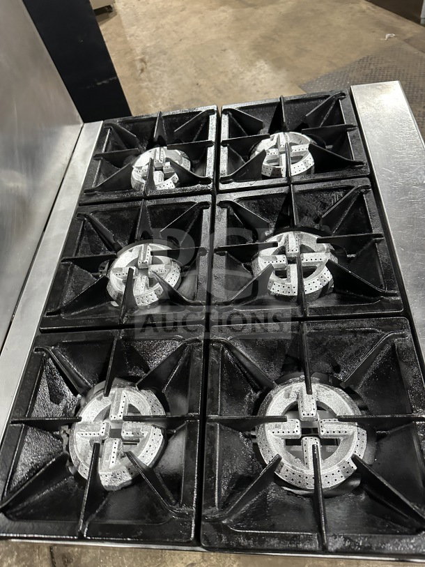 Qualite model QLG36NG stainless steel natural gas range with six burners, backsplash, and overhead salamander shelf.