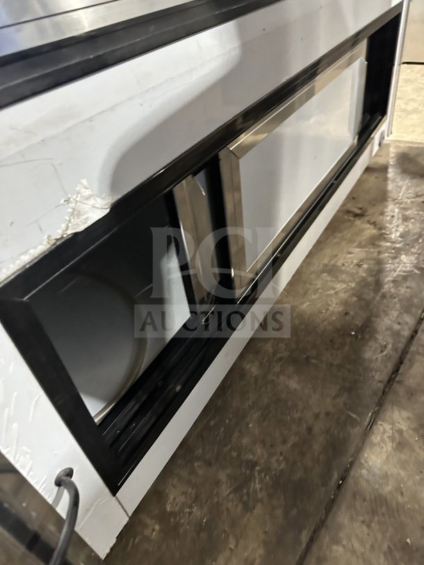 Leader ERHD60ESR stainless steel deli/meat merchandiser display with slanted glass, adjustable shelves, and rear sliding doors.