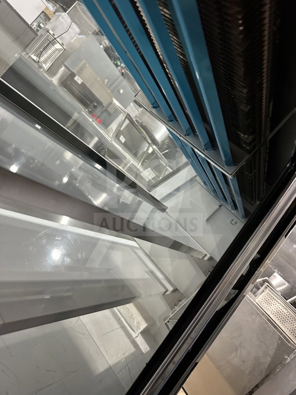 Leader Model ERHD60ESR stainless steel deli/meat merchandiser with slanted glass, adjustable shelves, storage, rear doors.