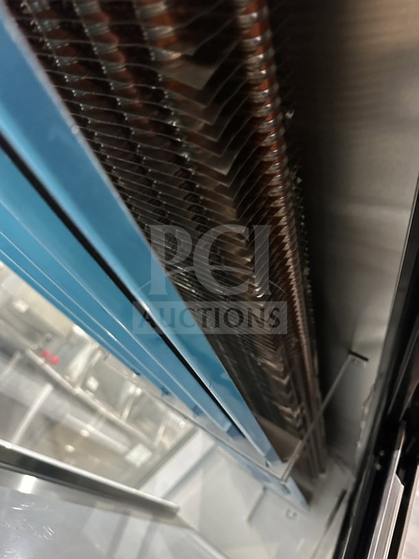 Stainless steel interior of Leader ERHD60ESR refrigerated merchandiser display, showing slanted glass and shelving details.