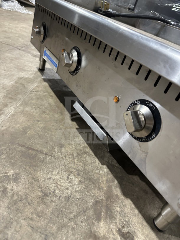 Standard Range SREG36 stainless steel 36" electric griddle with thermostatic controls, back and side splash, on legs. Model SR-EG36.