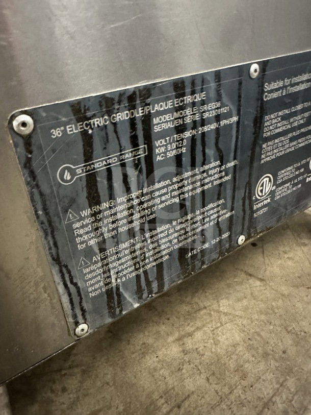 Standard Range 36" stainless steel electric countertop griddle, model SR-EG36, with thermostatic controls and splash guards. Serial number SR23081121.