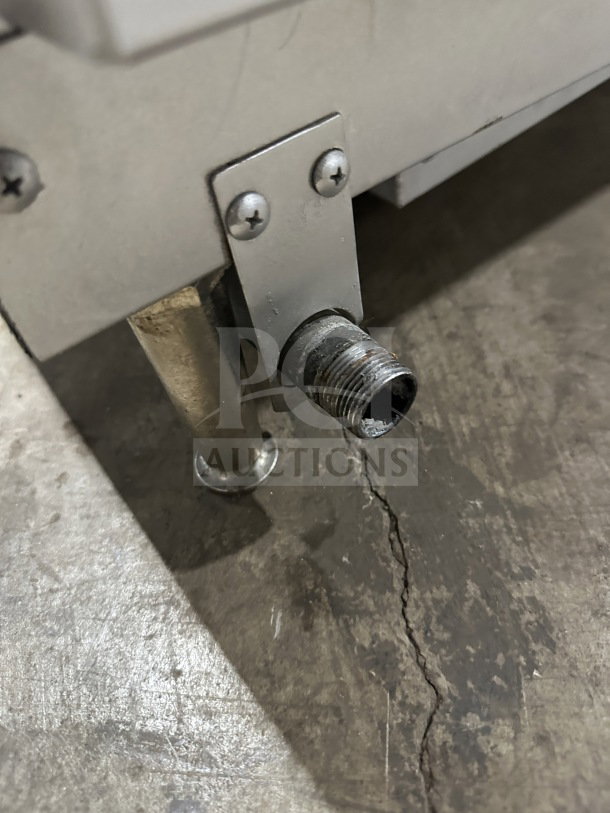 Commercial stainless steel radiant charbroiler, Model TMRC36, countertop design. Gas/electric powered. Visible pipe connection.