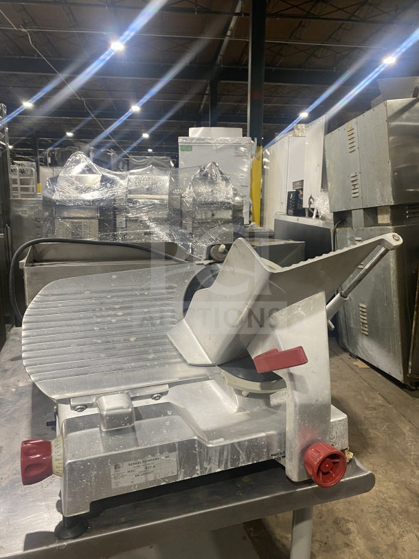 Berkel Model 827 A stainless steel deli meat slicer, electric-powered, 115V, serial EN-1005977, on legs, used condition.