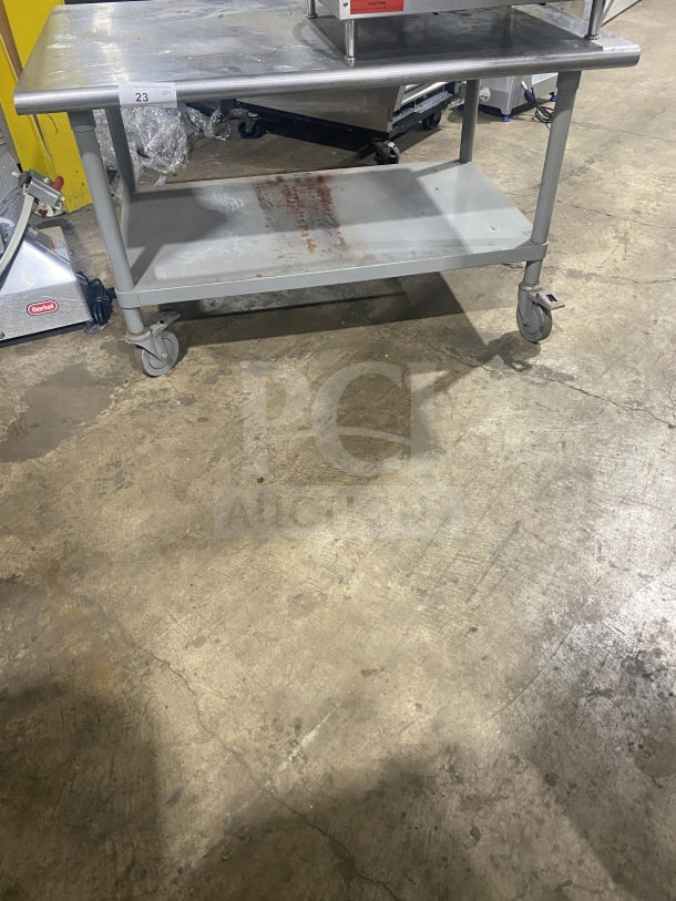 Commercial stainless steel two-compartment equipment stand on casters, maintained condition, includes shelf, visible label "23 QTY".