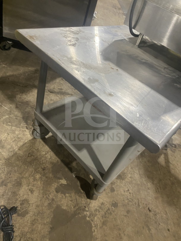 Commercial stainless steel two-compartment equipment stand on casters, well-maintained, featuring sturdy construction.