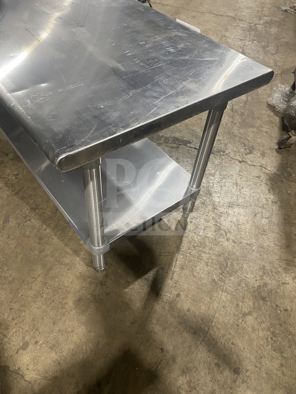 L&J stainless steel two-compartment equipment stand, commercial grade, on legs, sturdy, used condition.
