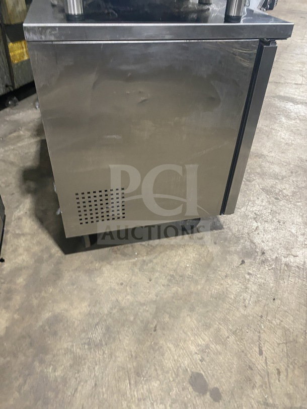 Stainless steel two-door undercounter refrigerator or freezer; maintained, good condition, with ventilation grid on the side.