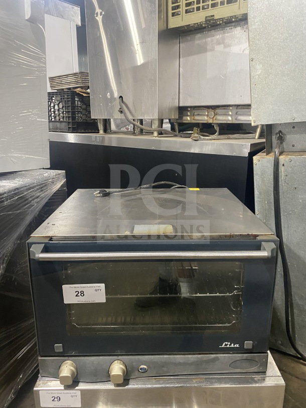 Unox Cadco Lisa Series countertop convection oven, model XAF013, with metal racks, 120V. Visible wear on exterior.