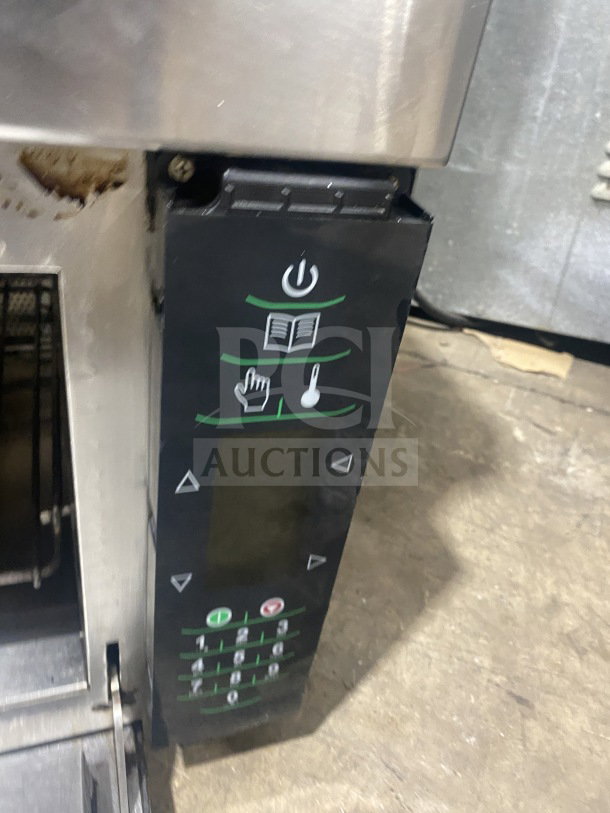Amana AXP22 stainless steel rapid cook turbo oven, countertop model. Features digital display and control panel. Used condition.