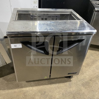 Turbo Air TST-36SD stainless steel refrigerated sandwich prep table with cutting board, 2-door storage, on casters.