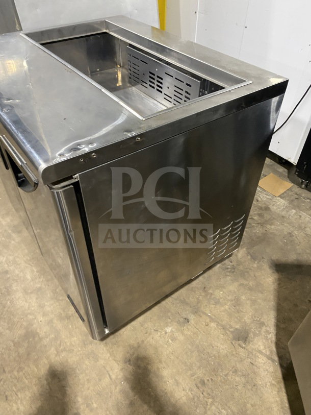 Turbo Air TST36SD refrigerated sandwich prep table with stainless steel body, 2-door storage, commercial cutting board, on casters.