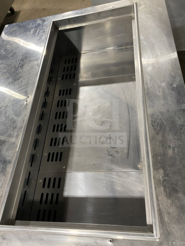 Turbo Air TST-36SD stainless steel refrigerated prep table, two-door storage, commercial cutting board, on casters.