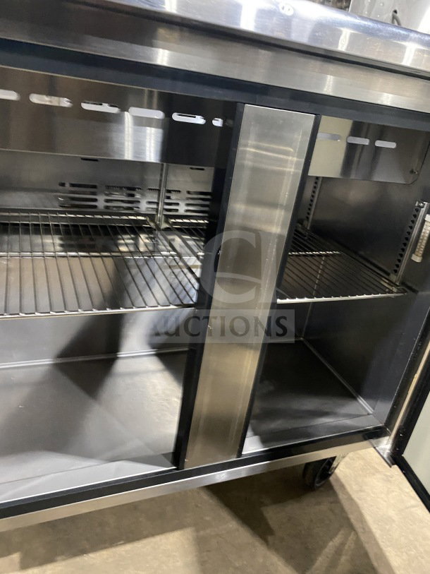 Turbo Air TST-36SD refrigerated sandwich prep table with cutting board, stainless steel, 2-door storage, on casters.