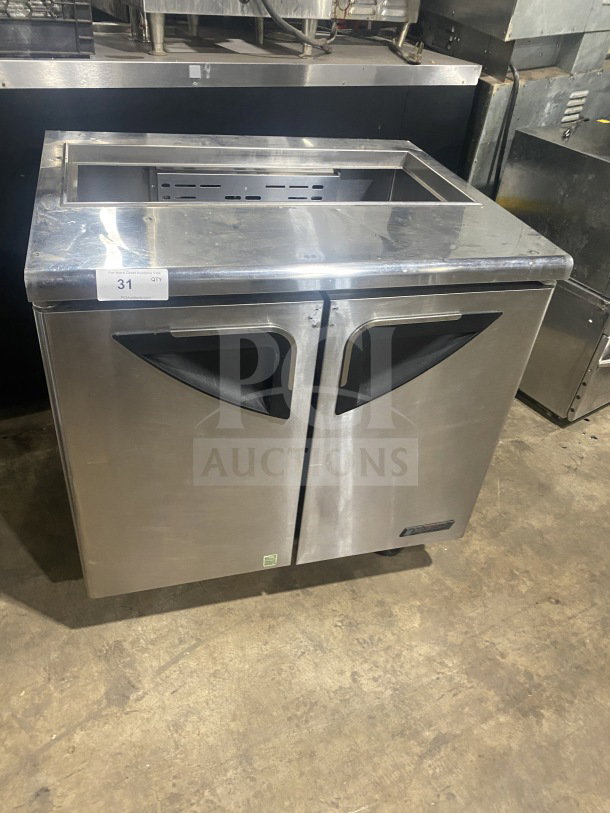 Turbo Air stainless steel refrigerated sandwich prep table, Model TST-36SD, with cutting board, dual-door storage, on casters.