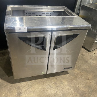 Turbo Air stainless steel refrigerated sandwich prep table, Model TST-36SD, with cutting board, dual-door storage, on casters.