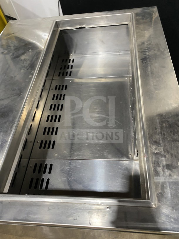 Turbo Air TST36SD stainless steel refrigerated prep table, with cutting board and two-door storage, on casters, model TST36SD.