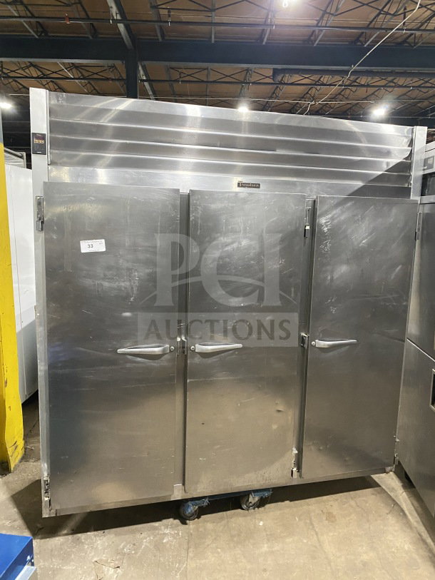 Traulsen G31010 Commercial Stainless Steel Triple Door Reach-In Freezer, Energy Star, with casters and poly-coated racks.