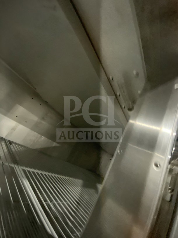 Traulsen G31010 triple door reach-in freezer interior showing poly coated wire rack, stainless steel walls.