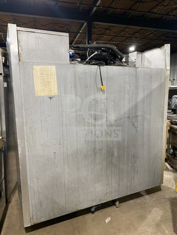 Traulsen stainless steel triple door freezer, Model G31010, electric, Energy Star certified, on casters, with racks.