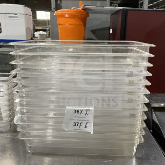 Thunder Group PLPA8001 commercial polycarbonate 1/1 4" clear food pans, stack of six, with auction labels indicating quantities.