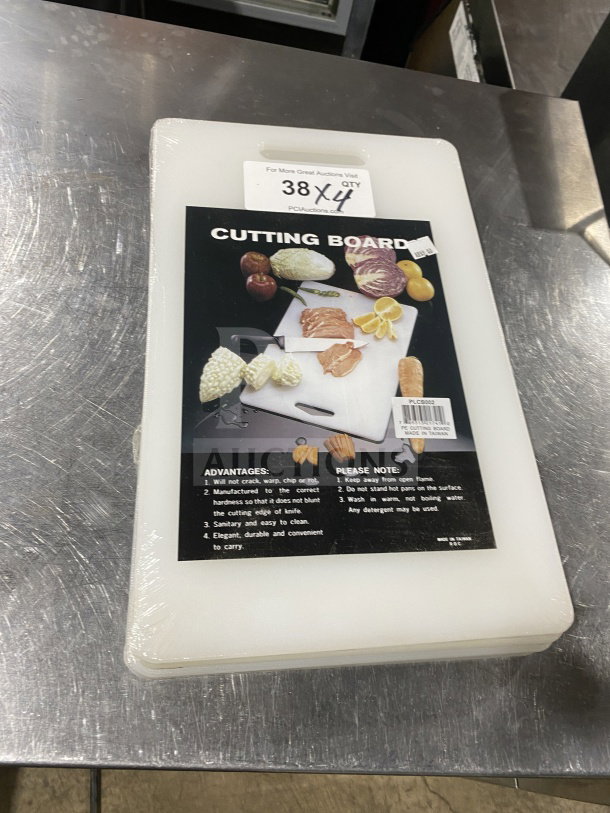 Brand new Thunder Group PLCB002 non-skid white plastic cutting board with handle hole. Stack of four.