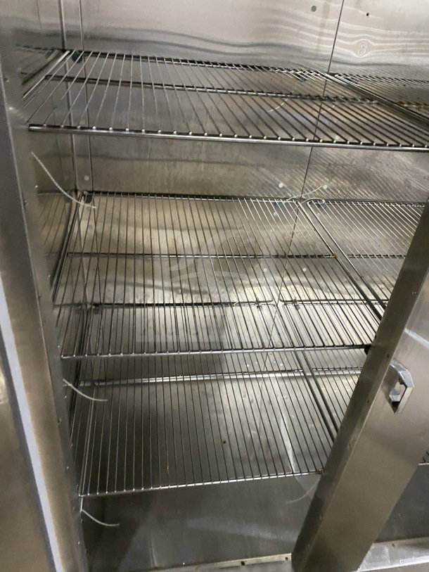 Traulsen Spec-Line Series RLT232WUTFHS stainless steel 2-door reach-in freezer, chrome plated wire racks, on casters.