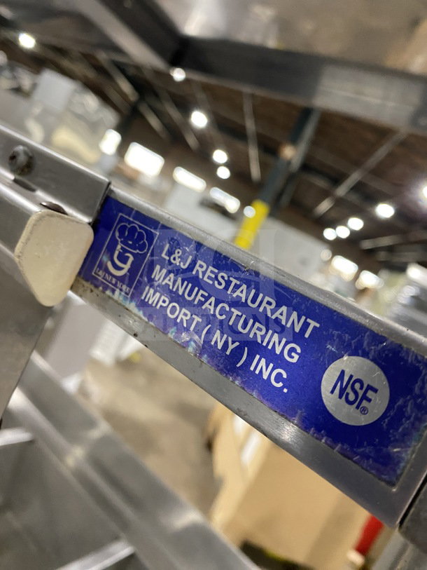 L&J 5-well stainless steel steam table with double overshelf and enclosed sliding 2-door base, NSF certified label visible.