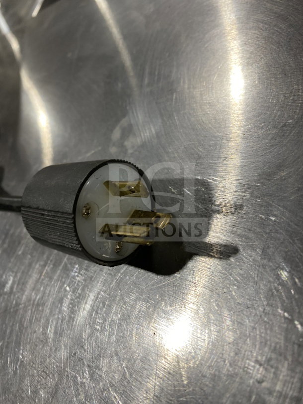 Close-up of a power plug for the Carinval King CM16DBL dual crepe maker, showing prongs and connector details.