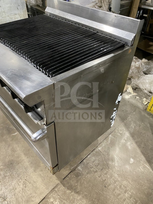 American Range commercial stainless steel gas range with full charbroiler, standard oven base, wired oven rack, and casters.