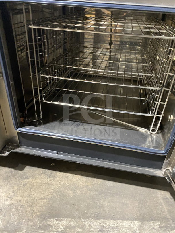 Electrolux Air-O-Convect AOS062GKP1 stainless steel combi oven with wired rack, Touchline controls, on legs, natural gas powered.